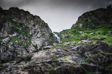Pristine waterfall in monsoon season in the Himalayas mountain during a trek in Himachal Pradesh, india	