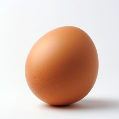 Single Brown Egg on Smooth White Surface for Culinary Themes