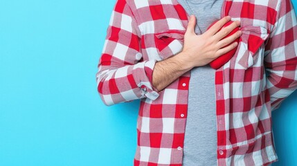 Man in Plaid Shirt with Hand on Heart Against Blue Background