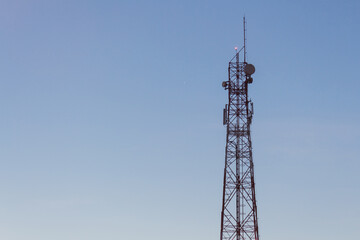 Telecommunication tower urban setting infrastructure image clear sky environment elevated viewpoint connectivity concept