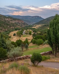 Fototapeta premium Soft pastel cloudscape over tranquil valley creating a surreal and peaceful landscape with transparent atmosphere in standard view at dawn.