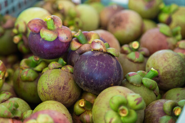 Fresh mangosteen fruits at market tropical environment close-up view vibrant produce collection for healthy eating