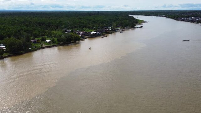 Aerial Majesty of Quibd&oacute;: River, Faith, and Rainforest. Drone views of Quibd&oacute;, Choco, Colombia, featuring the Atrato River, boats, rainforest, and the iconic cathedral. A vibrant mix of nature.