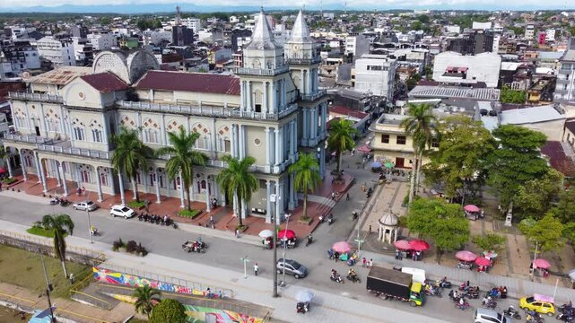 Aerial Majesty of Quibd&oacute;: River, Faith, and Rainforest. Drone views of Quibd&oacute;, Choco, Colombia, featuring the Atrato River, boats, rainforest, and the iconic cathedral. A vibrant mix of nature.