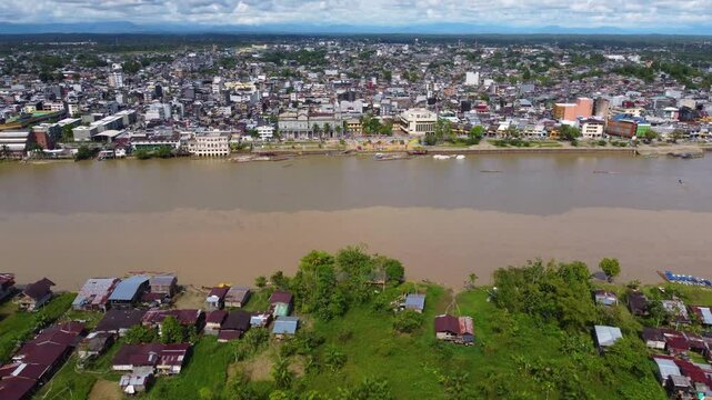 Aerial Majesty of Quibd&oacute;: River, Faith, and Rainforest. Drone views of Quibd&oacute;, Choco, Colombia, featuring the Atrato River, boats, rainforest, and the iconic cathedral. A vibrant mix of nature.