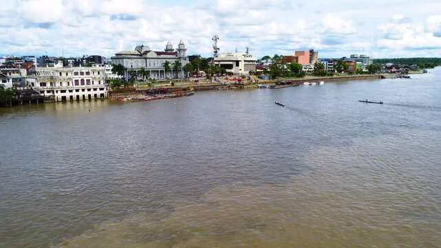 Aerial Majesty of Quibd&oacute;: River, Faith, and Rainforest. Drone views of Quibd&oacute;, Choco, Colombia, featuring the Atrato River, boats, rainforest, and the iconic cathedral. A vibrant mix of nature.