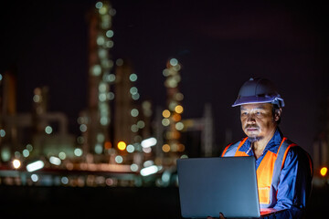 Industrial engineer or worker night inspection at refinery or petrochemical plant walkie-talkie hand and digital tablet intersection of technology, safety, and human  in modern industrial work.