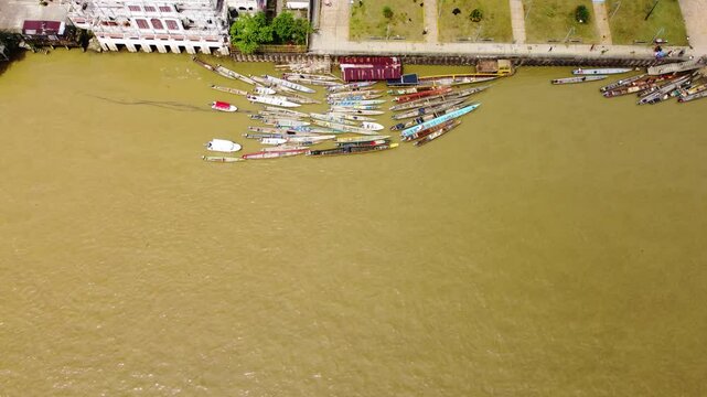Aerial Majesty of Quibd&oacute;: River, Faith, and Rainforest. Drone views of Quibd&oacute;, Choco, Colombia, featuring the Atrato River, boats, rainforest, and the iconic cathedral. A vibrant mix of nature.