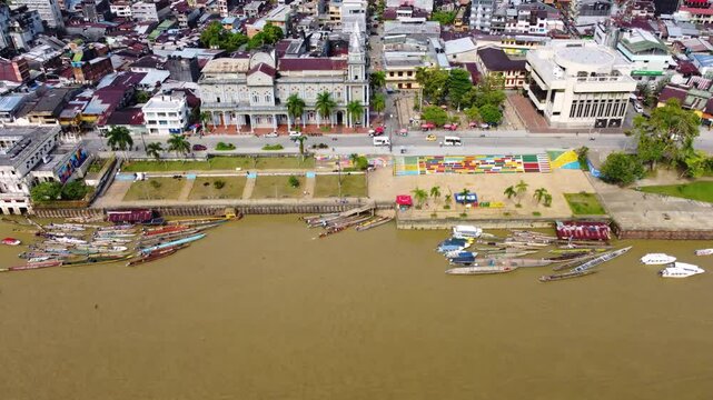 Aerial Majesty of Quibd&oacute;: River, Faith, and Rainforest. Drone views of Quibd&oacute;, Choco, Colombia, featuring the Atrato River, boats, rainforest, and the iconic cathedral. A vibrant mix of nature.