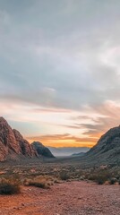 Naklejka premium Sunset over desert valley, rocky mountains.