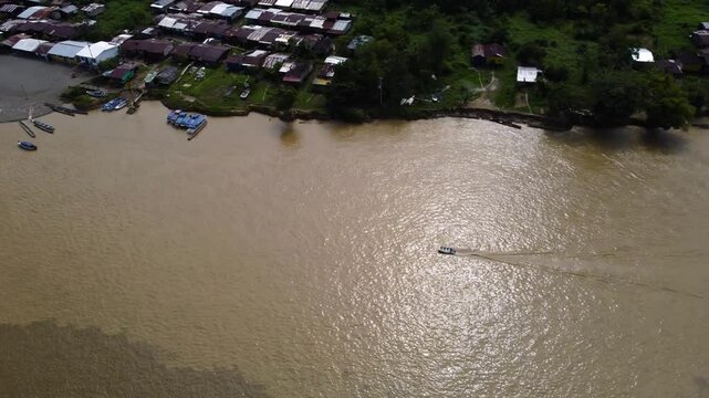 Aerial Majesty of Quibd&oacute;: River, Faith, and Rainforest. Drone views of Quibd&oacute;, Choco, Colombia, featuring the Atrato River, boats, rainforest, and the iconic cathedral. A vibrant mix of nature.
