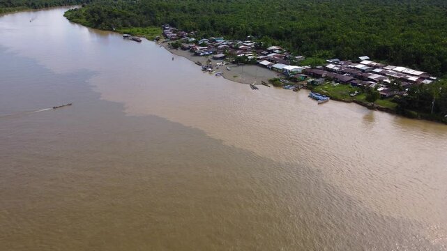 Aerial Majesty of Quibd&oacute;: River, Faith, and Rainforest. Drone views of Quibd&oacute;, Choco, Colombia, featuring the Atrato River, boats, rainforest, and the iconic cathedral. A vibrant mix of nature.