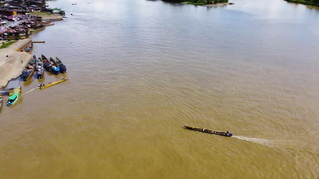 Aerial Majesty of Quibd&oacute;: River, Faith, and Rainforest. Drone views of Quibd&oacute;, Choco, Colombia, featuring the Atrato River, boats, rainforest, and the iconic cathedral. A vibrant mix of nature.