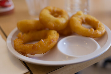 Delicious onion rings local diner food photography indoor setting close-up view culinary delight