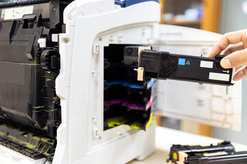 Technician Holding ink printer toner low for replace new or fix repair problem paper or print...
