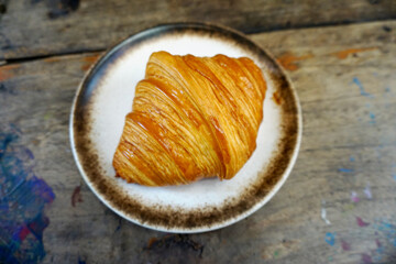 Croissant in dish, Nice dessert on wooden table