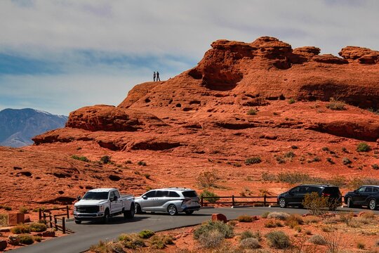 People Climbing on the Red Rocks of Pioneer Park in St. George Utah.