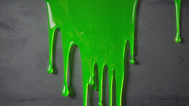 Bright green slime dripping down gray wall, textured surface, vibrant liquid flowing, abstract visual, playful creative design element