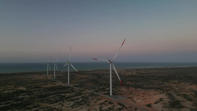 Drone aerial view of wind turbines at sunset on the coast of La Guajira, Colombia