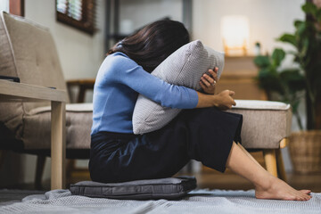 A woman sitting at home is sad, disappointed and upset. Person are disappointed in love.