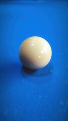 A Perfectly Positioned Cue Ball Ready for the Next Shot on Blue Felt