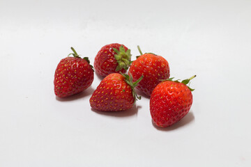 Fresh strawberries gathered together studio food photography clean background close-up juicy treats