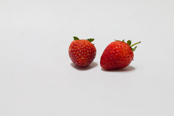 Fresh strawberries on white background food photography simple presentation natural light close-up healthy eating