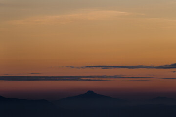 Sunset over mountain peak scenic landscape nature photography tranquil environment wide angle view serene atmosphere
