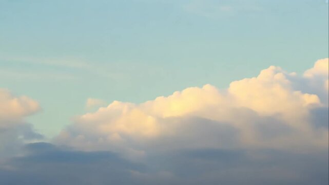 Soft Puffy Clouds in a Bright Blue Sky at Sunset Time