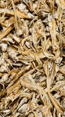 A close-up showcase of dried anchovies, a staple in Asian cuisine, reveals their delicate texture and rich, salty flavor profile