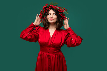 Cheerful brunette in bright red gown with berry headpiece