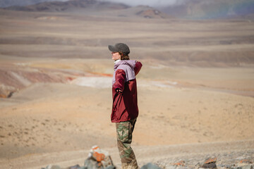girl in a cap and a burgundy windbreaker