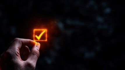 Hand selecting glowing checkmark in dark background