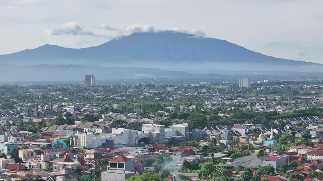 Aerial shot of Bogor with Mount Gede Pangrango in the background -slide left