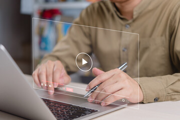 Businessman watching and interacting with live streaming video on laptop. Ideal for online...