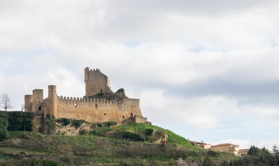 Castle of the medieval village of Frias on top of a mountain with some clouds in the white sky