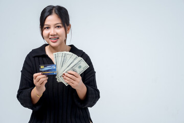 Young woman holding banknotes and credit cards