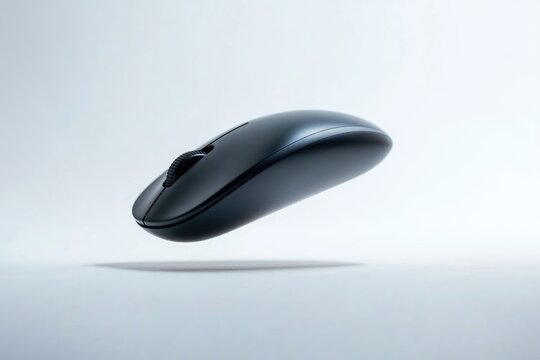 A sleek, black wireless computer mouse hovers elegantly against a minimalist white backdrop.