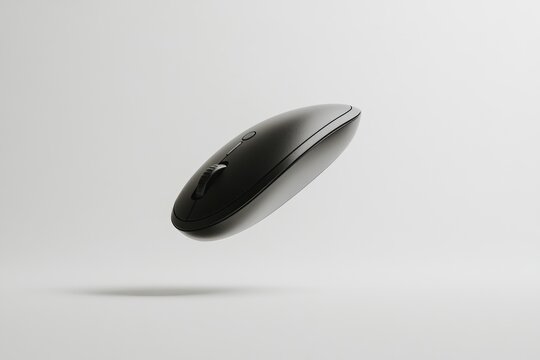 A sleek, black wireless computer mouse hovers against a minimalist white backdrop.
