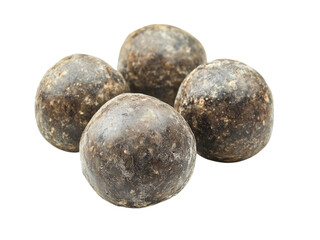 Close-up View of Four Dark Brown Spherical Objects Resembling Herbal Balls or Medicinal Remedies
