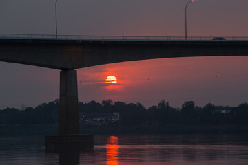 Sunset over river bridge scenic viewpoint nature photography calm environment urban landscape