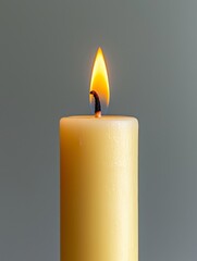 Elegant Yellow Candle with Glowing Flame, Symbol of Hope and Serenity
