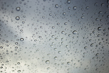 Rain droplets on glass urban environment nature photography moody atmosphere close-up view reflection concept