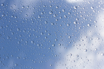 Raindrops on glass urban skyline nature photography cloudy day close-up view refreshing atmosphere