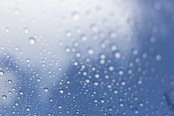 Raindrops on glass urban setting macro photography blue sky close-up nature's beauty