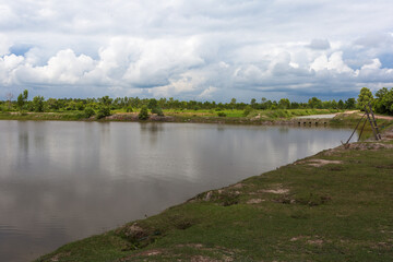 Tranquil river scene with lush greenery rural landscape nature photography overcast sky peaceful atmosphere