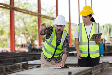 Engineer, Teamwork, Construction site. Team of engineer construction inspecting construction of precast concrete walls at construction site. Foreman builder control of work at site work