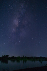 Fototapeta premium Starry night sky over serene lake nature photography tranquil environment wide angle view cosmic beauty