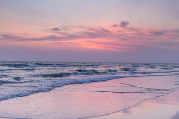 Serene sunset over waves beachfront landscape photography coastal environment tranquil viewpoint nature's beauty