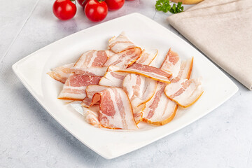 Raw pork tenferloin with bacon